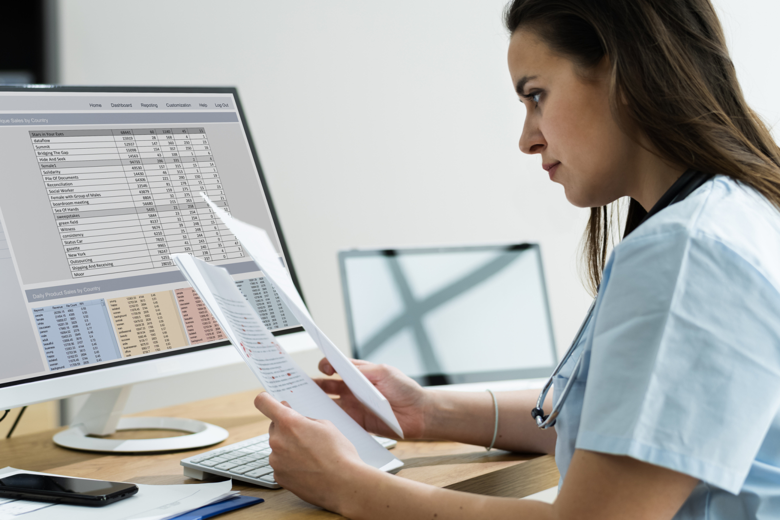 Medical analyst reviewing billing codes and spreadsheet data on paper documents and computer screens