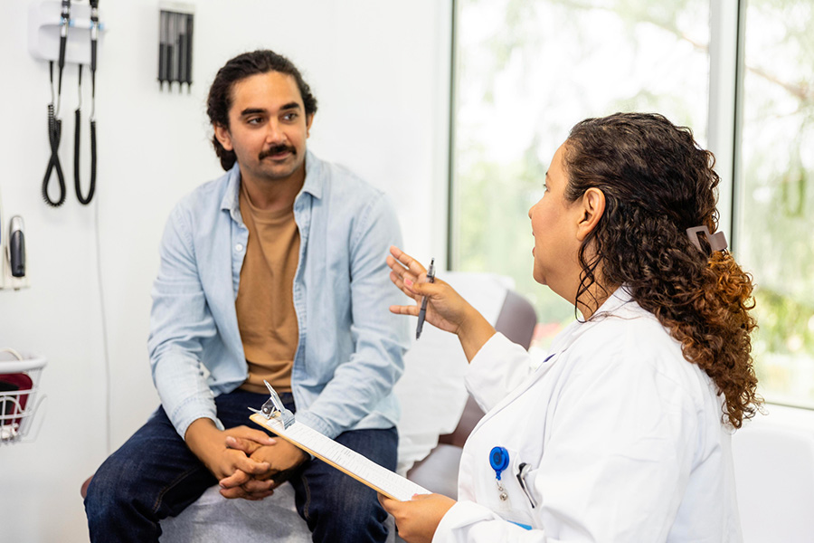 Man listens intently to female doctor's advice